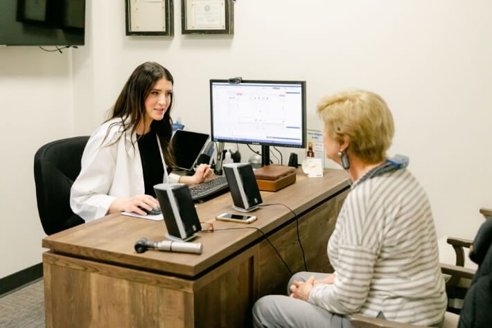 Allison Audiology's tinnitus expert with a female patient at the Houston office