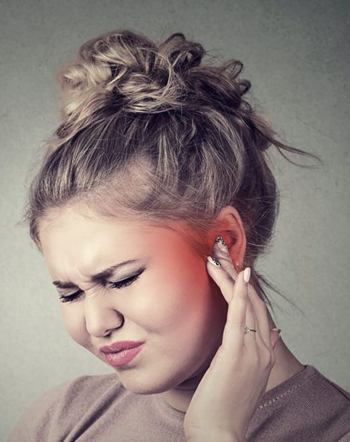 A female suffering from tinnitus aka ringing in the ears